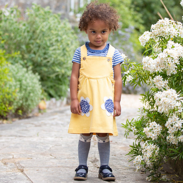 Girl in mini pocket pinafore